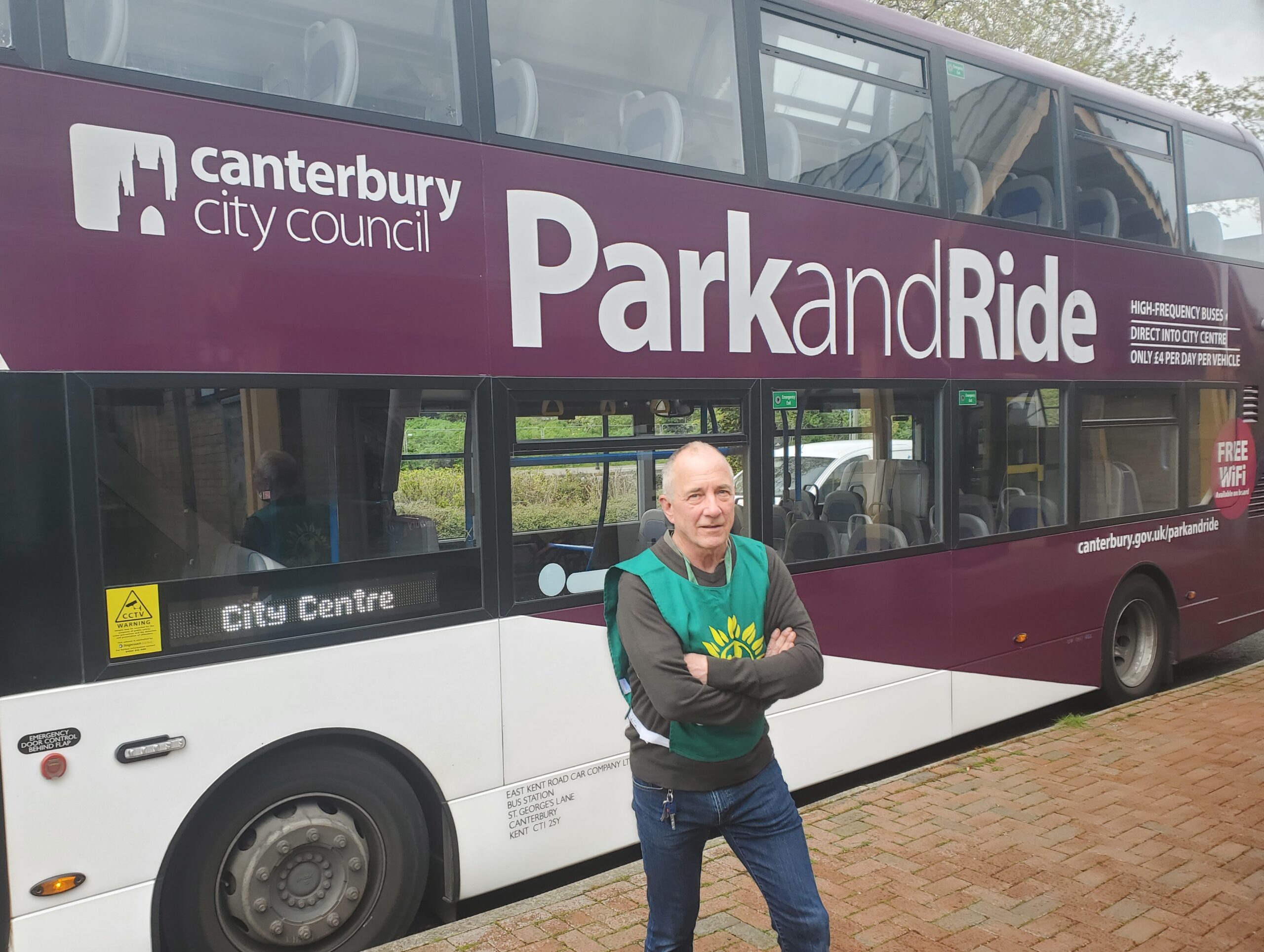 Green Party Councillor Andy Harvey stands in front of another empty park and ride bus at Sturry